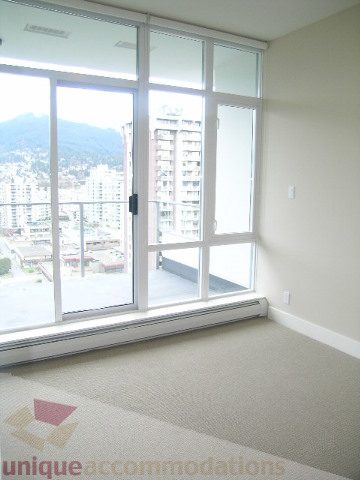 Spacious living room with large windows offering a stunning city view. - 1903 - 1320 Chesterfield Street, North Vancouver