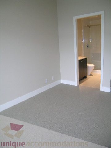 Spacious den with carpeted floor and a glimpse of the bathroom beyond. - 1903 - 1320 Chesterfield Street, North Vancouver