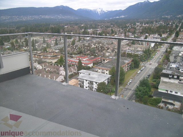 Spacious balcony with stunning city view and modern railings, perfect for enjoying the mountain backdrop.