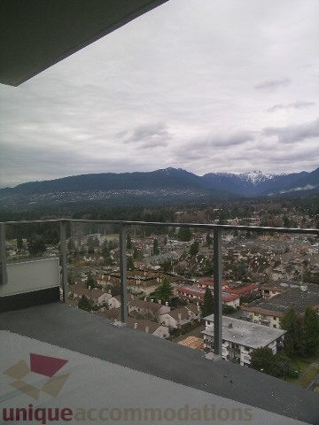 Spacious balcony with stunning city and mountain view, perfect for enjoying the North Vancouver scenery.