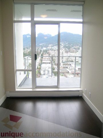 Spacious living room with hardwood floors and a stunning city view. - 1903 - 1320 Chesterfield Street, North Vancouver