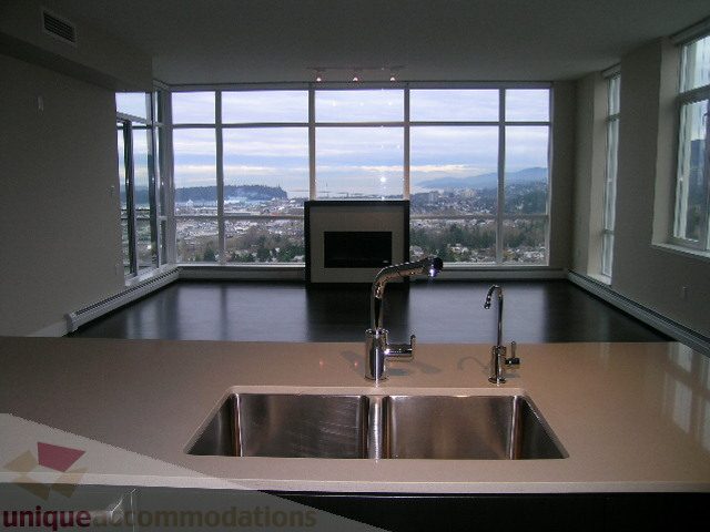 Spacious kitchen with modern sink, sleek countertops, and stunning city view. - 1903 - 1320 Chesterfield Street, North Vancouver