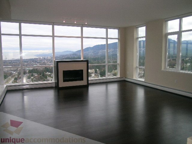 Spacious living room with hardwood floors and a stunning city view. - 1903 - 1320 Chesterfield Street, North Vancouver