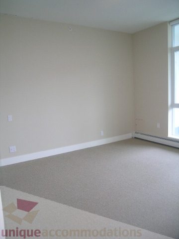 Spacious den with carpeted floor and large windows, perfect for a cozy reading nook. - 1903 - 1320 Chesterfield Street, North Vancouver