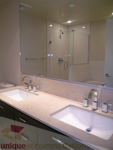 Modern bathroom with granite countertops and a sleek shower enclosure. - 1903 - 1320 Chesterfield Street, North Vancouver