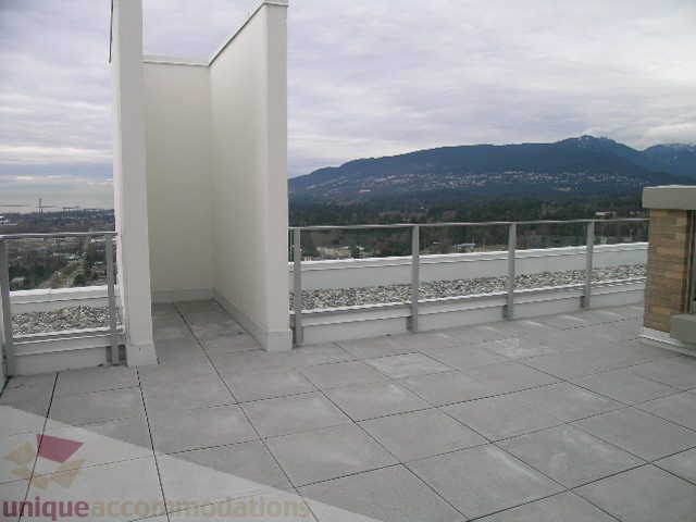 Spacious rooftop patio with stunning mountain view and modern tile flooring. - 1903 - 1320 Chesterfield Street, North Vancouver