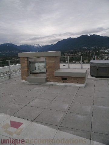 Spacious rooftop patio with a city view and modern furnishings. - 1903 - 1320 Chesterfield Street, North Vancouver
