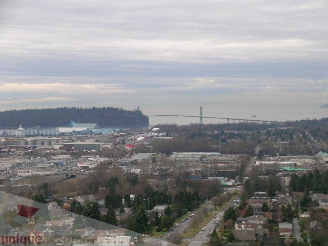 Spacious 2-bedroom + den condo with stunning city view, featuring modern furnishings and panoramic windows.