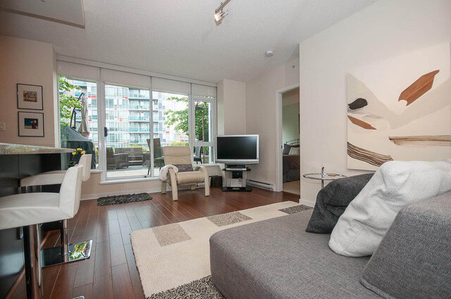 Spacious living room with hardwood floors, city view, and modern furnishings. - 903 - 821 Cambie Street, Vancouver Downtown