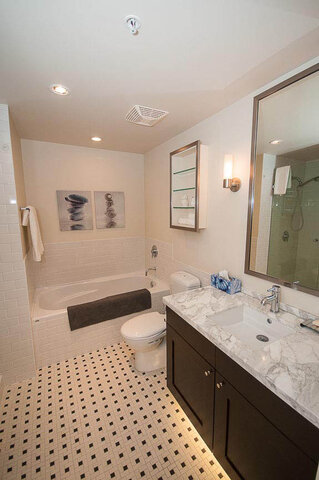 Spacious bathroom with marble countertops and black-and-white tiled floor. - 903 - 821 Cambie Street, Vancouver Downtown