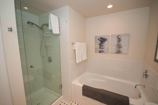 Spacious bathroom with glass shower, subway tile, and serene artwork. - 903 - 821 Cambie Street, Vancouver Downtown