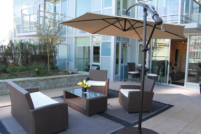 Spacious patio with wicker furniture, umbrella, and city view. - 903 - 821 Cambie Street, Vancouver Downtown
