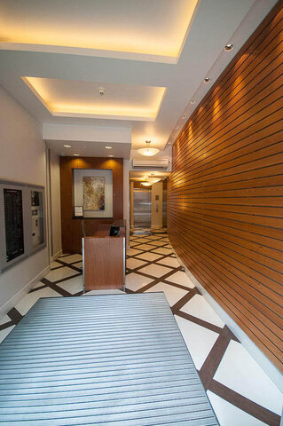 Foyer with wooden paneling and geometric tile flooring, leading to a modern elevator. - 903 - 821 Cambie Street, Vancouver Downtown