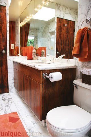 Bathroom with marble countertops and wooden cabinets, featuring a modern design and a warm, inviting ambiance. - 1330 Sinclair Street, West Vancouver