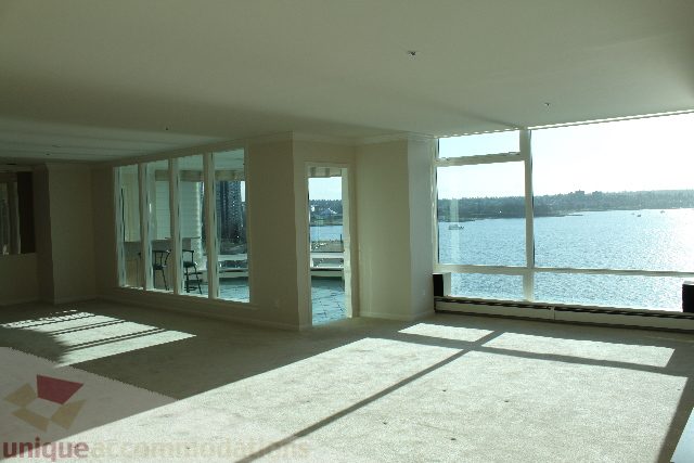 Spacious living room with large windows, city view, and modern furnishings. - 900 - 1919 Beach Ave, Vancouver Downtown