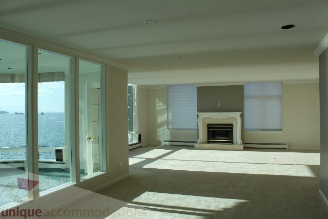 Bright living room with ocean view and modern furnishings. - 900 - 1919 Beach Ave, Vancouver Downtown