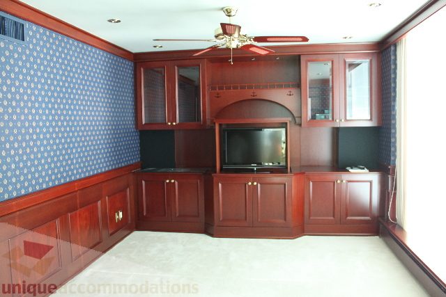 Bright kitchen with dark wood cabinetry and a built-in TV, featuring a ceiling fan and blue wallpaper. - 900 - 1919 Beach Ave, Vancouver Downtown