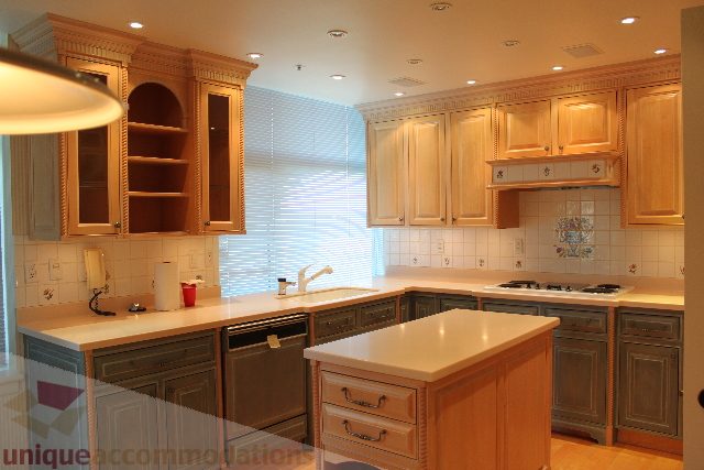 Bright kitchen with light wood cabinets, granite countertops, and a city view. - 900 - 1919 Beach Ave, Vancouver Downtown