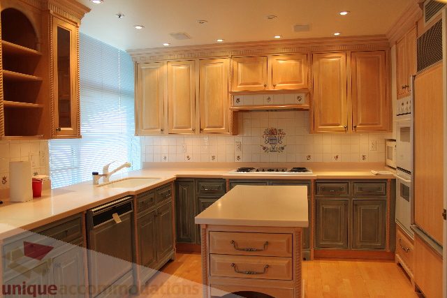 Bright kitchen with light wood cabinets, white countertops, and a window with blinds. - 900 - 1919 Beach Ave, Vancouver Downtown