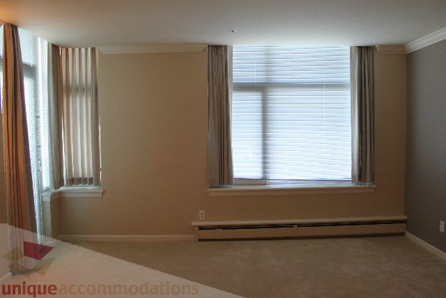 Furnished living room with large windows and neutral decor. - 900 - 1919 Beach Ave, Vancouver Downtown