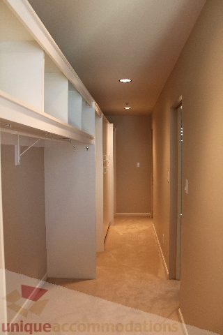Spacious hallway with built-in shelving and carpeted floors. - 900 - 1919 Beach Ave, Vancouver Downtown