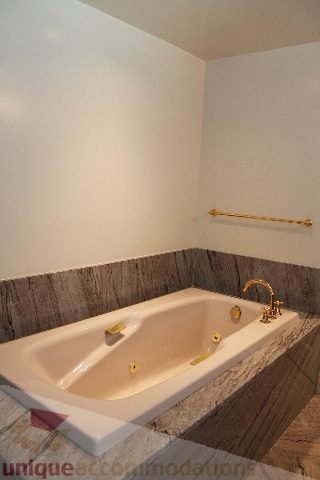 Furnished bathroom with marble countertops and gold fixtures. - 900 - 1919 Beach Ave, Vancouver Downtown