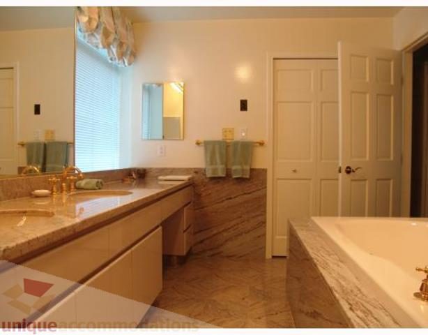 Spacious bathroom with marble countertops and wooden flooring. - 900 - 1919 Beach Ave, Vancouver Downtown