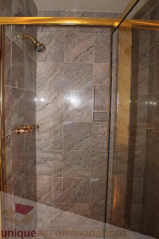 Bright shower with marble tiles and gold accents. - 900 - 1919 Beach Ave, Vancouver Downtown
