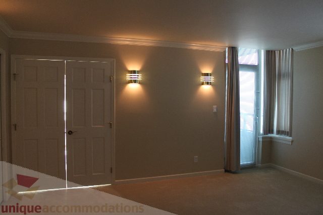 Bright living room with wall sconces and large windows. - 900 - 1919 Beach Ave, Vancouver Downtown