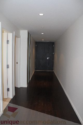 Furnished hallway with dark wood floors and white walls. - 2407 - 1011 West Cordova Street, Vancouver Downtown