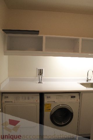 Bright laundry room with white countertops and a modern sink. - 2407 - 1011 West Cordova Street, Vancouver Downtown
