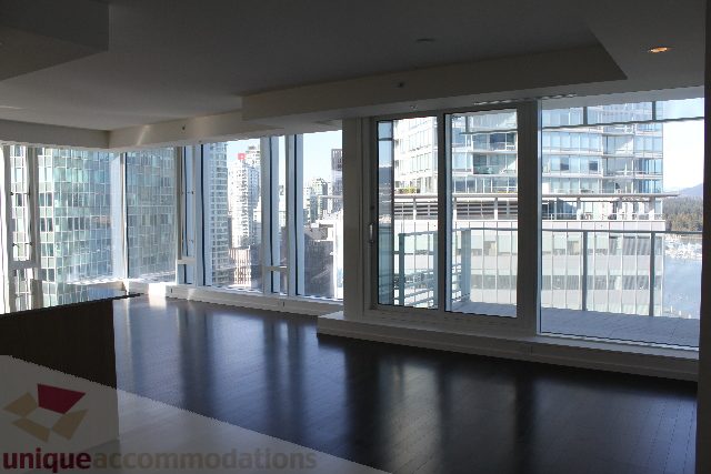 Spacious living room with large windows offering a stunning city view. - 2407 - 1011 West Cordova Street, Vancouver Downtown