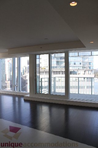 Spacious living room with hardwood floors and a city view. - 2407 - 1011 West Cordova Street, Vancouver Downtown