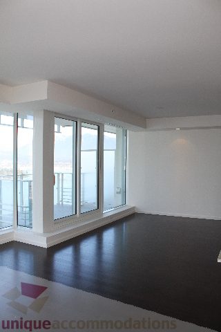 Spacious living room with hardwood floors and a city view. - 2407 - 1011 West Cordova Street, Vancouver Downtown