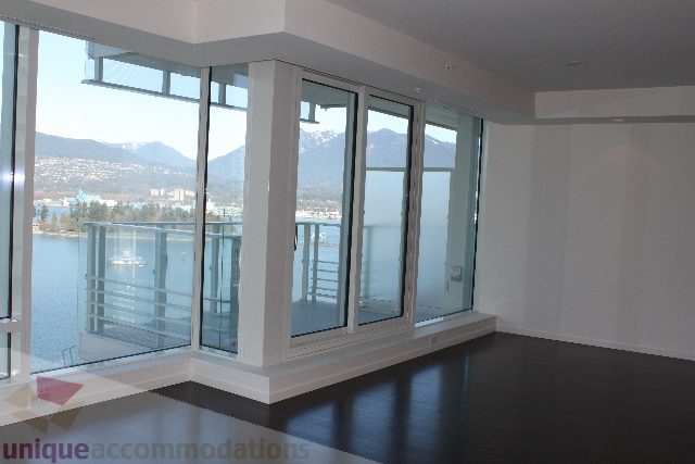 Bright living room with large windows, city view, and modern furnishings. - 2407 - 1011 West Cordova Street, Vancouver Downtown
