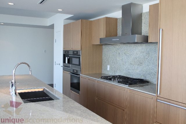 Modern kitchen with granite countertops and stainless steel appliances. - 2407 - 1011 West Cordova Street, Vancouver Downtown