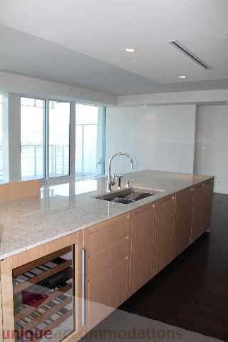 Bright kitchen with granite countertops, hardwood floors, and city view. - 2407 - 1011 West Cordova Street, Vancouver Downtown