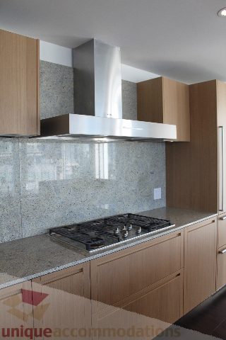 Bright kitchen with modern stainless steel range hood and granite countertops. - 2407 - 1011 West Cordova Street, Vancouver Downtown