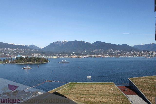 Furnished living room with city view and marina, overlooking mountains. - 2407 - 1011 West Cordova Street, Vancouver Downtown