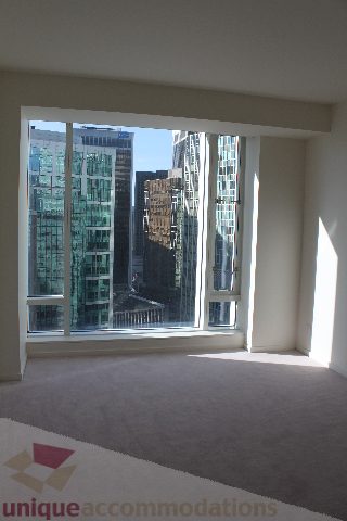 Bright living room with large windows offering a stunning city view. - 2407 - 1011 West Cordova Street, Vancouver Downtown