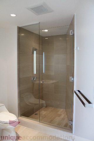 Shower with glass doors and wooden flooring. - 2407 - 1011 West Cordova Street, Vancouver Downtown