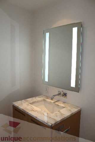 Bathroom with marble countertop and modern lighted mirror. - 2407 - 1011 West Cordova Street, Vancouver Downtown