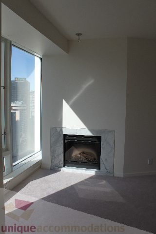 Living room with fireplace and city view. - 2407 - 1011 West Cordova Street, Vancouver Downtown