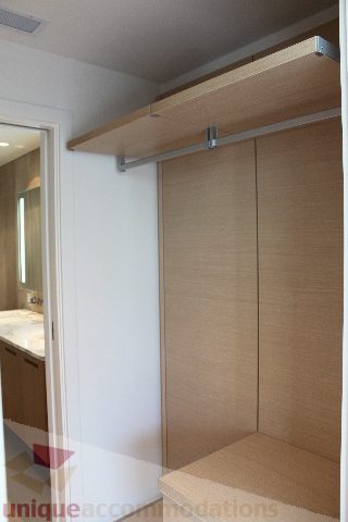 Furnished bedroom with built-in closet and wooden shelves. - 2407 - 1011 West Cordova Street, Vancouver Downtown