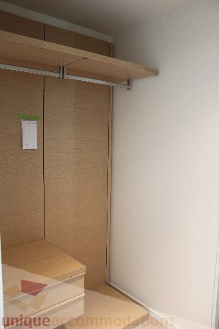 Furnished bedroom with sliding closet doors and a shelf above. - 2407 - 1011 West Cordova Street, Vancouver Downtown