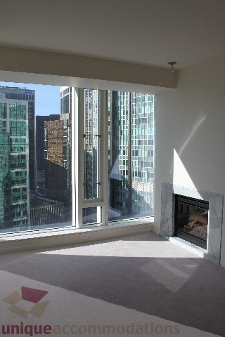 Spacious living room with large windows offering a stunning city view. - 2407 - 1011 West Cordova Street, Vancouver Downtown