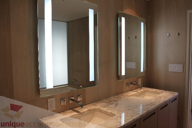 Bathroom with modern vanity, marble countertop, and wall-mounted lights. - 2407 - 1011 West Cordova Street, Vancouver Downtown