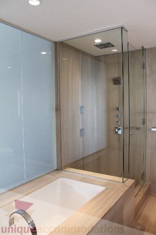 Spacious bathroom with modern glass shower and sleek countertop. - 2407 - 1011 West Cordova Street, Vancouver Downtown