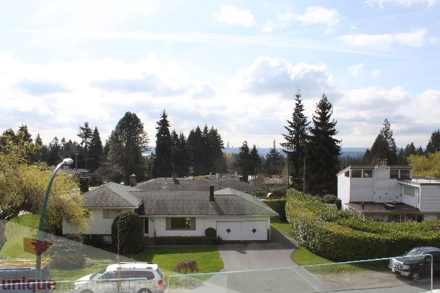 Spacious living room with modern furnishings and a city view. - 301 - 650 Evergreen Place, North Vancouver
