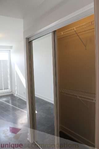 Spacious walk-in closet with sliding doors and built-in shelves. - 301 - 650 Evergreen Place, North Vancouver